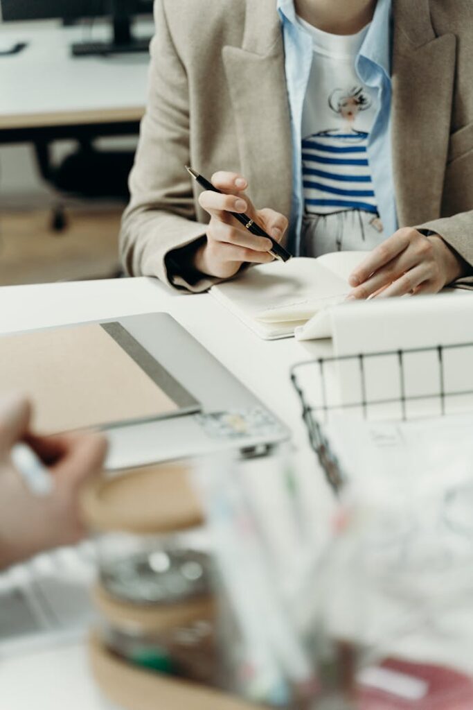 Business meeting with professionals making notes in an office setting.